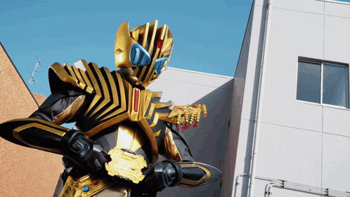 a man in a gold and black costume stands in front of a building holding a sword