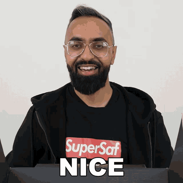 a man with a beard wearing a super saf nice shirt
