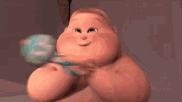 a cartoon baby is holding a rattle and smiling while sitting on a bed .