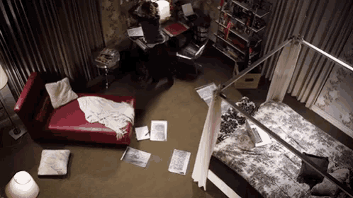 an aerial view of a bedroom with a bed and a chaise lounge