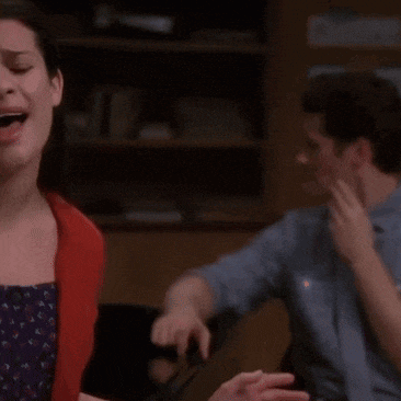 a woman is crying while a man looks on
