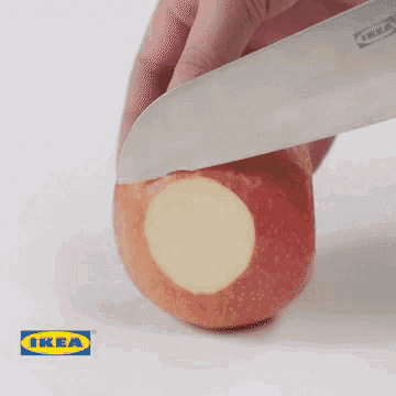 a person cutting an apple with an ikea logo in the corner