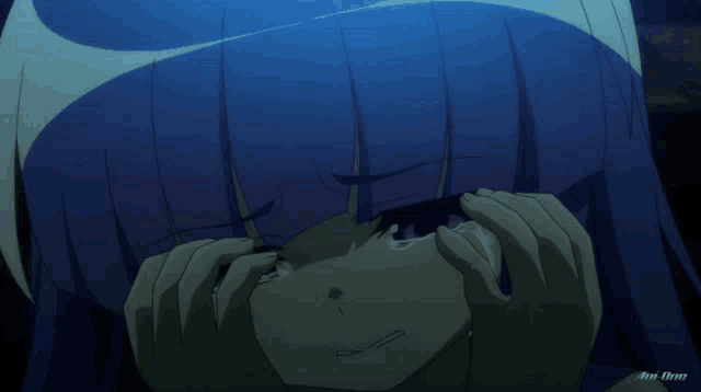 a girl with blue hair is crying in a dark room