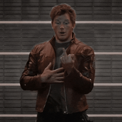 a man in a brown leather jacket is making a funny face