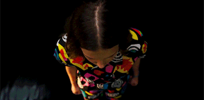 a close up of a woman wearing a colorful shirt .