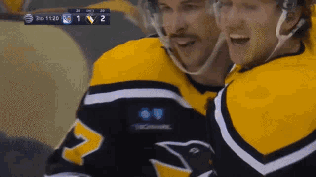 a hockey game is being played between the penguins and the rangers