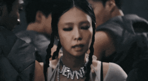 a woman wearing a necklace that says jenn on it