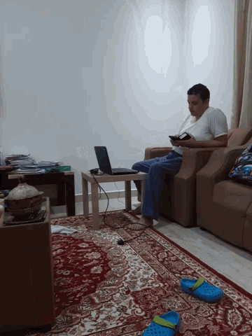 a man is sitting in a chair playing a video game