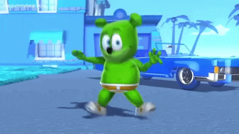 a green gummy bear is standing in front of a blue car .