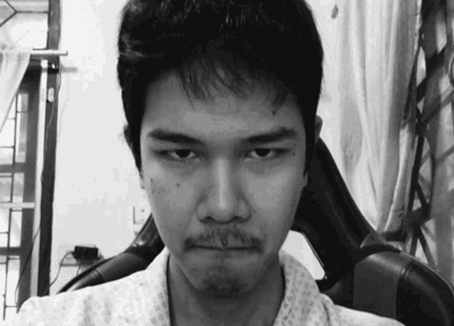 a black and white photo of a man making a funny face