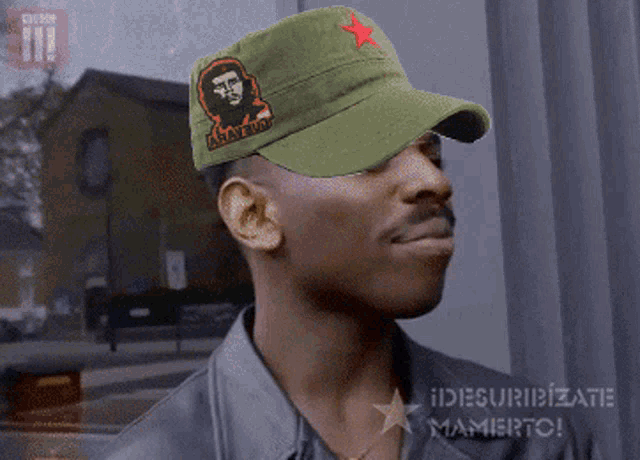 a man wearing a che guevara hat with a red star on the front