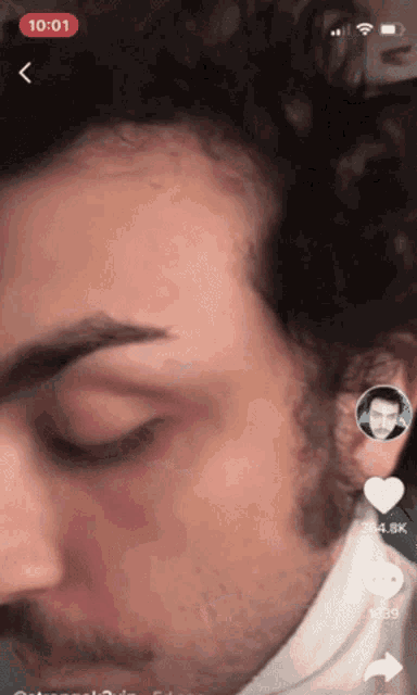 a close up of a man 's face with the time of 10:01 displayed