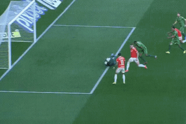 soccer players on a field with a sign that says quartzolit