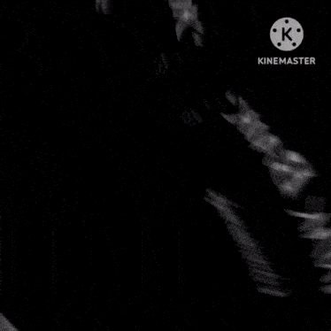 a black and white photo of a person 's hands with the letters k on the bottom