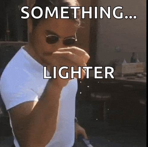 a man wearing sunglasses and a white shirt is holding a lighter in his hand and says something lighter