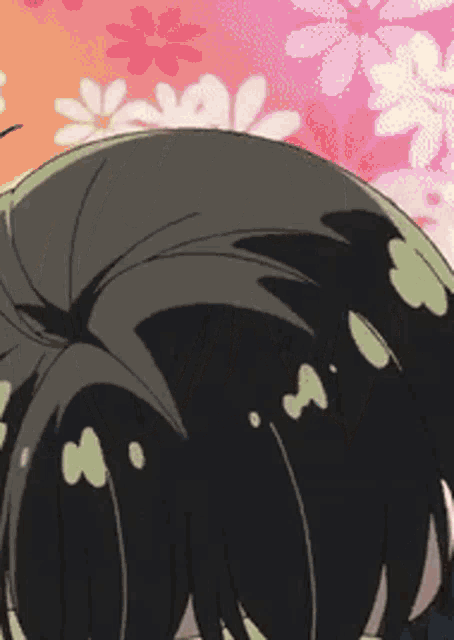 a close up of a person 's hair in front of flowers