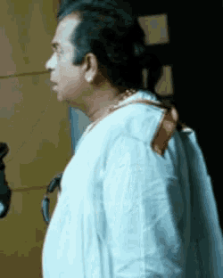 a man in a white shirt is standing in a room
