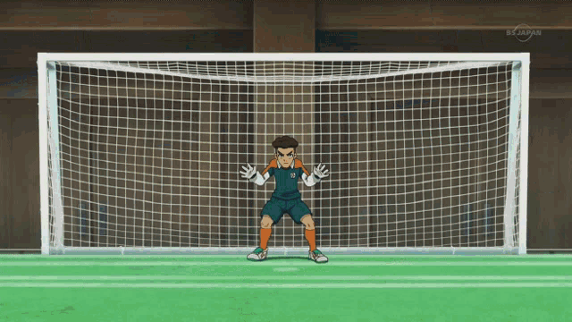 a soccer goalie stands in front of a soccer net that says bs japan on the bottom right