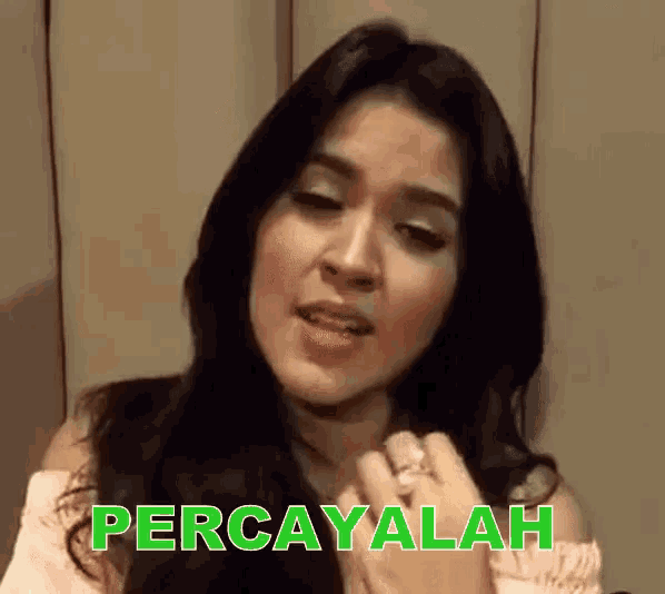 a woman is wearing a ring and the word percayalah is above her head
