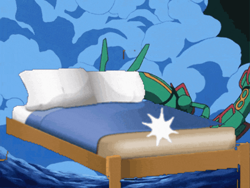 a bed with a blue blanket and white pillows with a pokemon on it