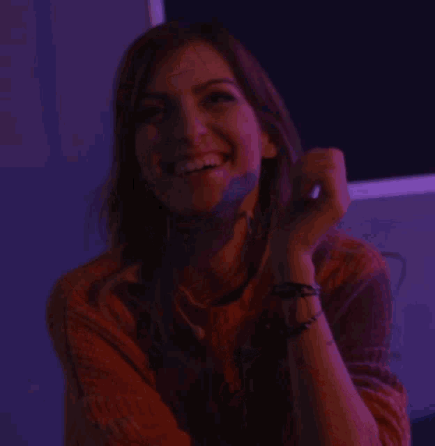 a woman with a purple light behind her