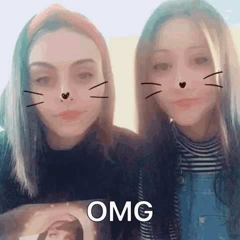 two girls with cat face filters on their faces are standing next to each other and one of them is saying omg .