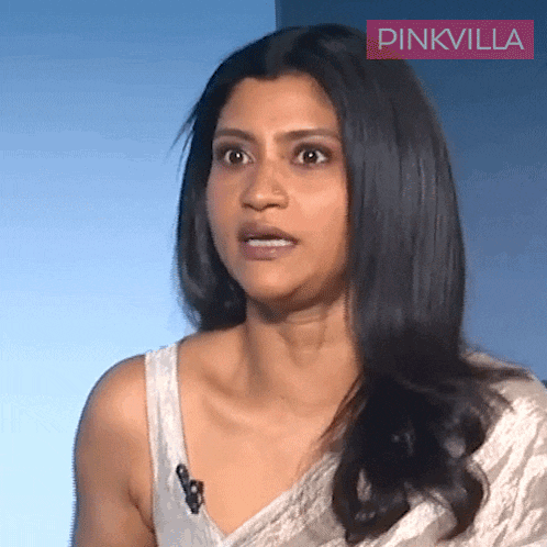 a woman wearing a white top with a pinkvilla logo on the bottom