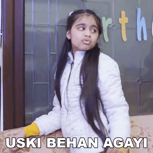 a girl sitting on a couch with the words " uski behan agayi " written above her