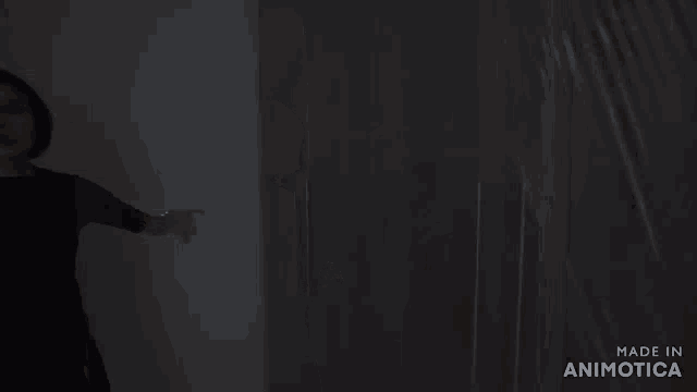 a person standing in a dark room with the words made in animatica on the bottom right