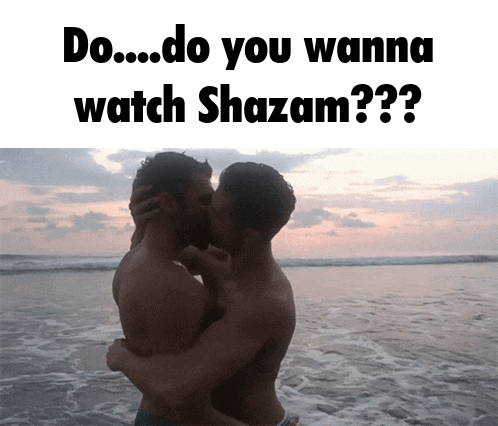 two shirtless men kissing on the beach with the words do you wanna watch shazam