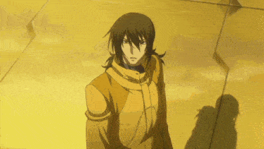 a man in a yellow jacket stands in front of a wall