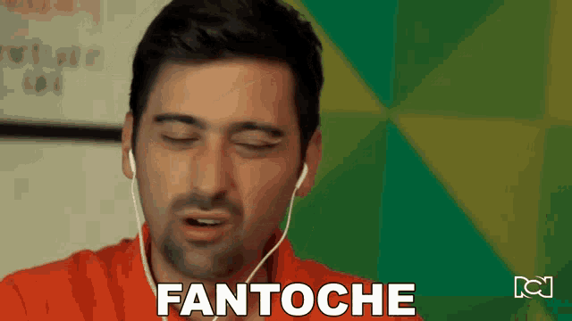 a man wearing ear buds says fantoche in front of a green wall