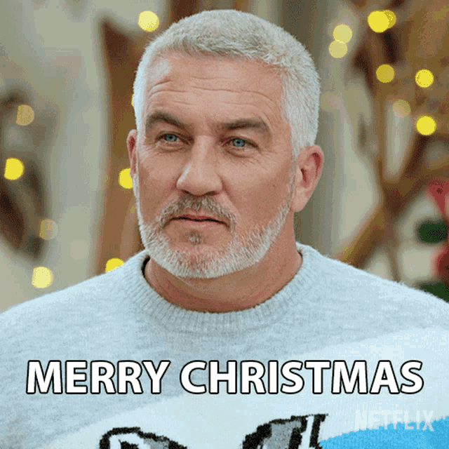 a man with a beard wears a sweater that says merry christmas on it