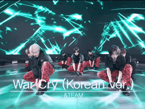 a group of men are kneeling down in front of a green screen that says war cry ( korean ver ) & team