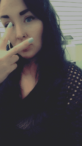 a woman with a nose ring is making a face