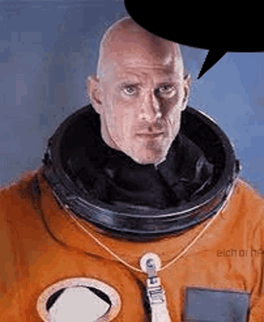a bald man in an orange space suit with a helmet on is talking .