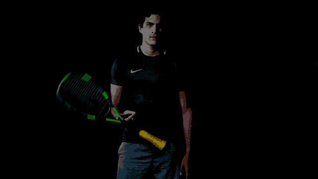 a man in a nike shirt holds a tennis racquet in his hand