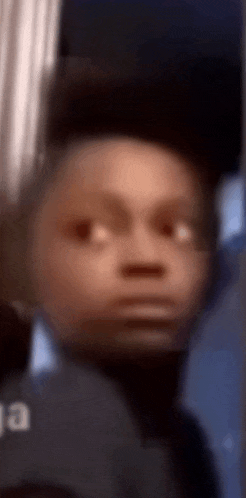 a blurry picture of a person 's face with a serious look on his face .