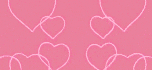 a kaleidoscope of pink hearts on a black background .