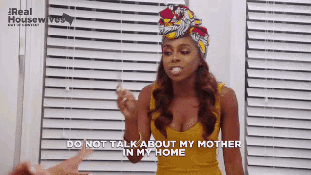 a woman says do not talk about my mother in my home in front of a window