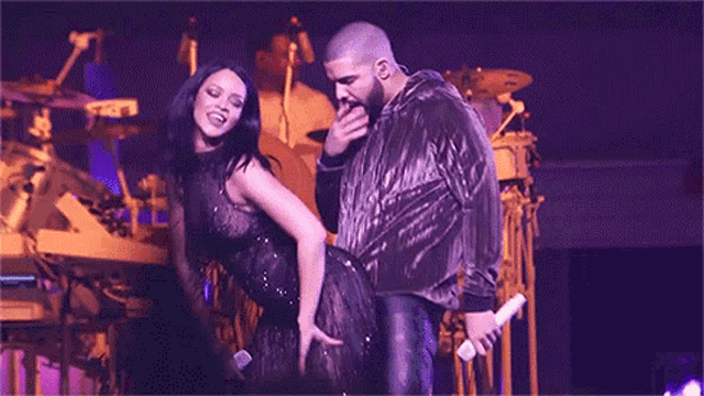 a man and a woman are dancing on stage .