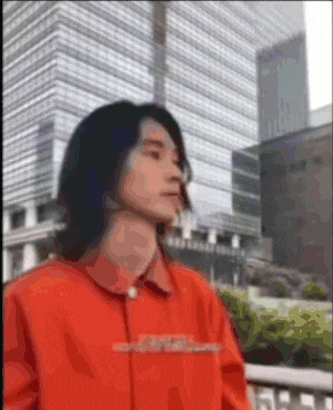 a blurry picture of a man in an orange shirt