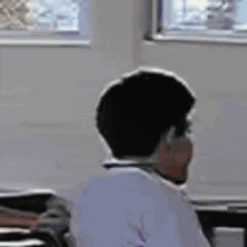 a close up of a man making a funny face while wearing a headset .