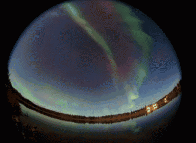 the aurora borealis is visible in the night sky