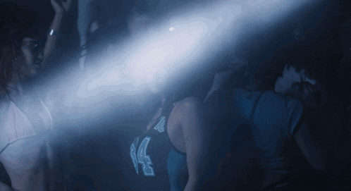 a woman in a blue tank top with the number 24 on it