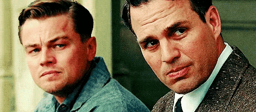 two men are standing next to each other and looking at something