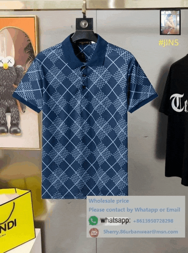 a blue t-shirt is hanging on a hanger next to a yellow fendi bag