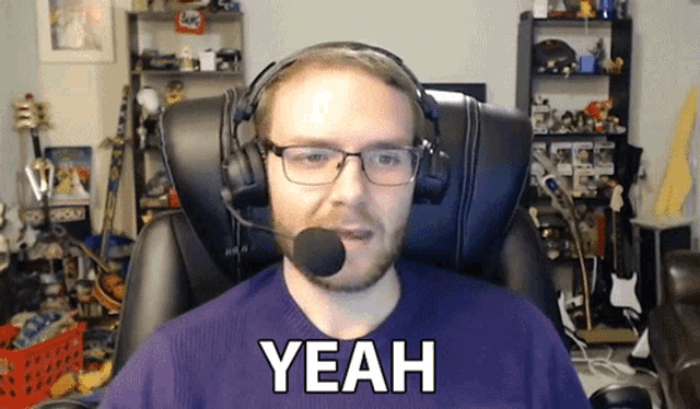a man wearing headphones and a microphone says " yeah "