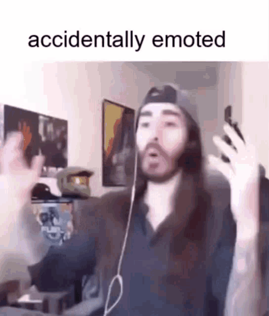 a man with long hair and a beard is wearing headphones and a hat .