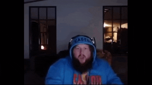 a man wearing a blue hoodie with the word okay on it